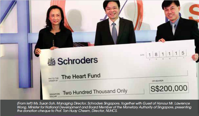 Ms.Susan Soh together with Mr.Lawrence Wong presenting cheque to Prof.Tan Huay Cheem